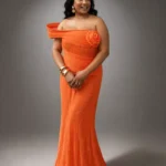 Tangerine Rose Zigham orange pleated evening gown worn by model